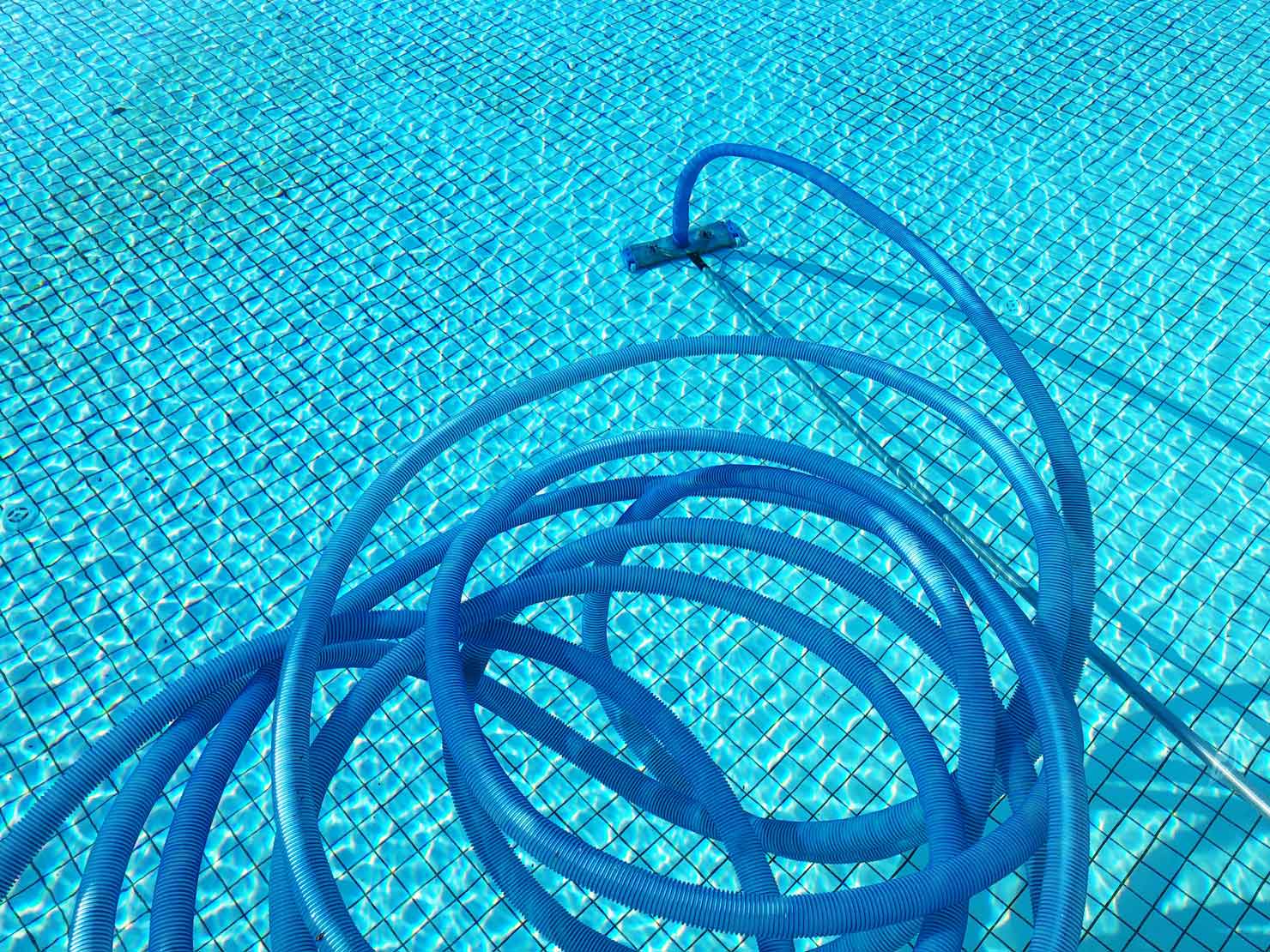 a blue hose in a pool